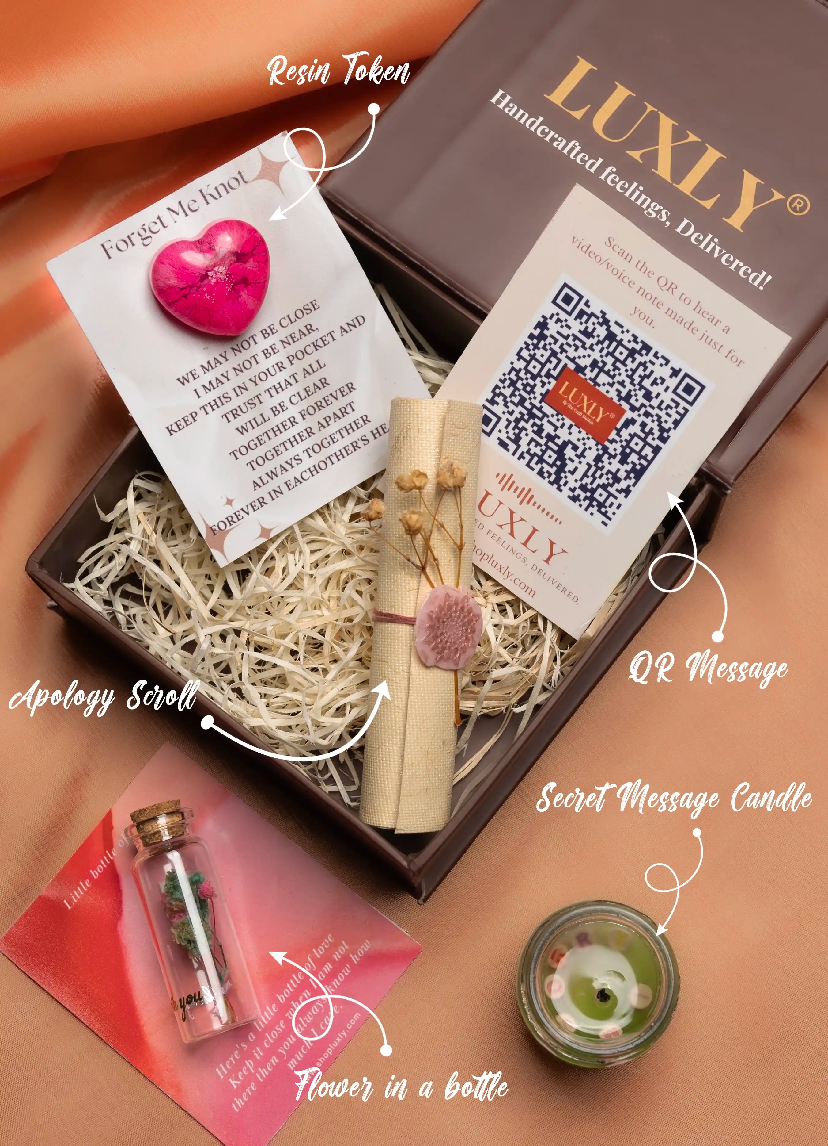 Luxly gift set with apology scroll, flower in a bottle, secret message candle, and QR message card.