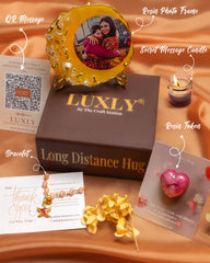 Luxly product display with photo frame, candle, and jewelry on a brown surface